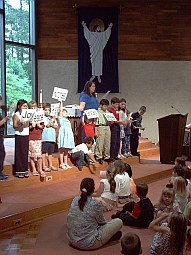 [Children participate in church.]