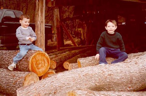 [Jacob and Joshua sit on Grandpa Karg's logs - Easter 2000]